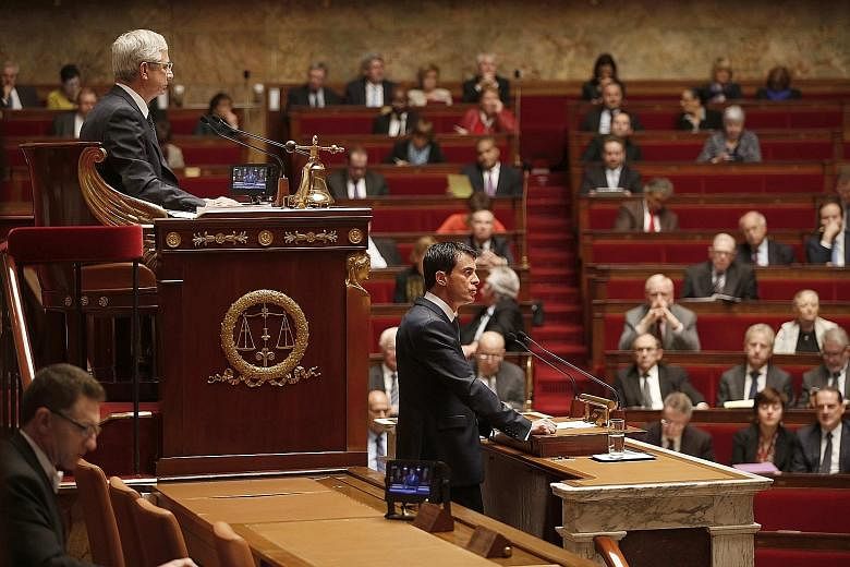 French Prime Minister Manuel Valls speaking during a debate to extend a state of emergency, at the National Assembly in Paris, France, yesterday, as French National Assembly president Claude Bartolone (top, left) listens.