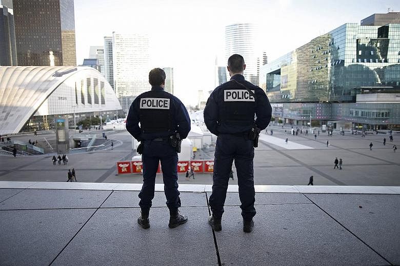 French police officers at the La Defense business district in Paris on Wednesday. One source told Reuters that a militant attack on La Defense was being prepared for yesterday. The district is home to some of France's biggest companies.