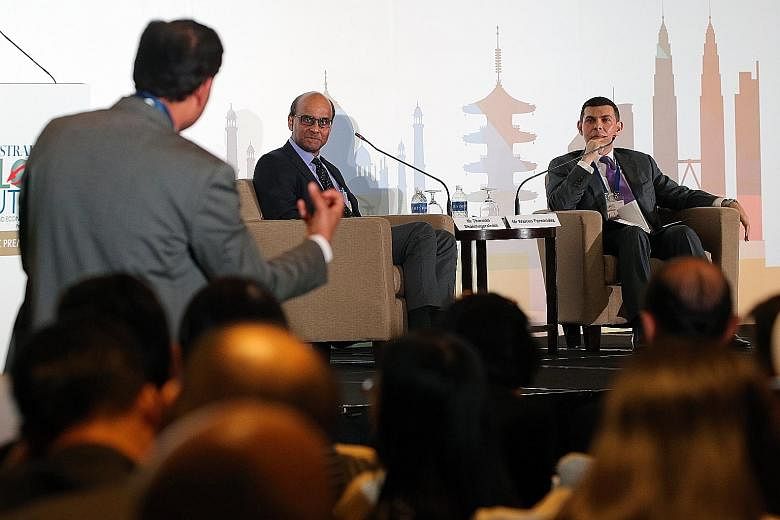One of the about 400 participants, including ST readers, at The Straits Times Global Outlook Forum engaging Deputy Prime Minister Tharman Shanmugaratnam during a Q&A session moderated by Straits Times editor Warren Fernandez yesterday.