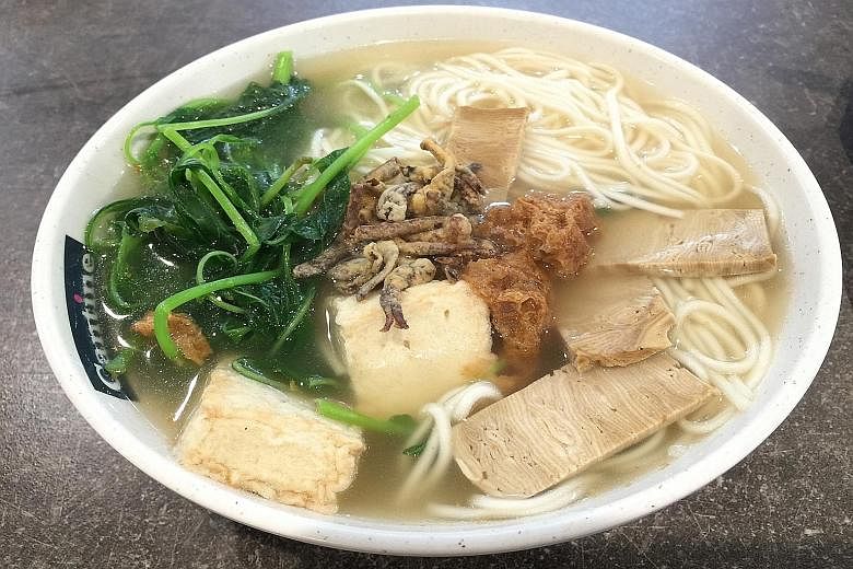 Xuan Miao Vegan's ban mian comes with a generous portion of spinach, vegetarian fish maw and mock meat slices topped with fried sliced mushrooms.
