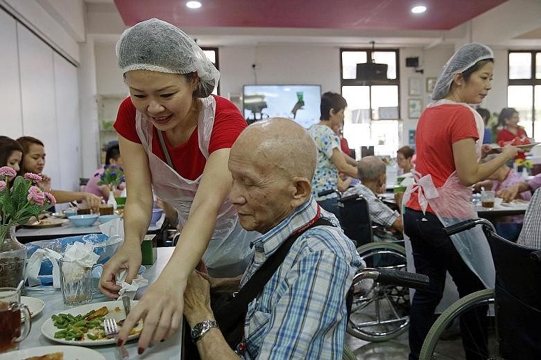 Finalists of Mrs Singapore World 2015 took on the role of hawkers for a day yesterday at Dignity Kitchen, Singapore's first hawker training school for disabled and disadvantaged people. Contestants, such as Ms Jean Koh, 44 (above), prepared lunch for