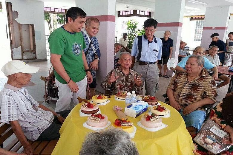Mr Raymond Khoo (in green) at a birthday celebration for needy residents of Lengkok Bahru. Such joint events are held on the first Saturday of every month.