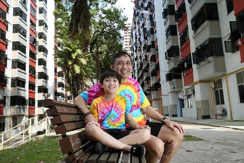 Mr Raymond Khoo and his son Justin. The eight-year-old boy helps his father distribute food to residents from six blocks of one-room rental units in Lengkok Bahru, one of Singapore's poorest neighbourhoods.