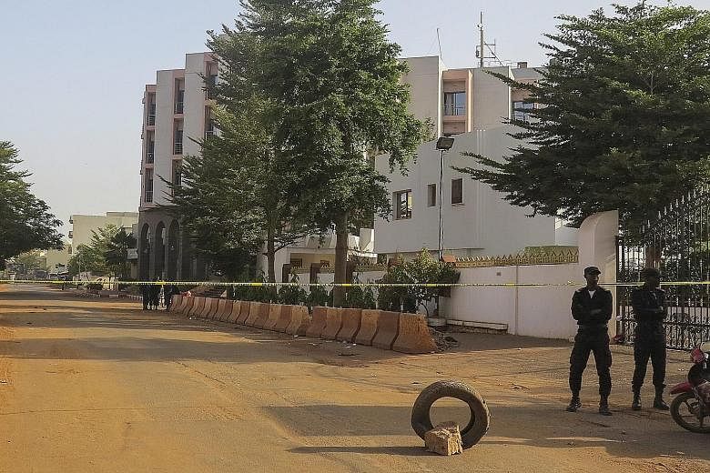 Blood-soaked drapes (above) on the floor of the Radisson Blu Hotel in Bamako after Friday's terror attack. Police yesterday cordoned off the hotel (left). Investigators are hunting at least three suspects linked to the assault.