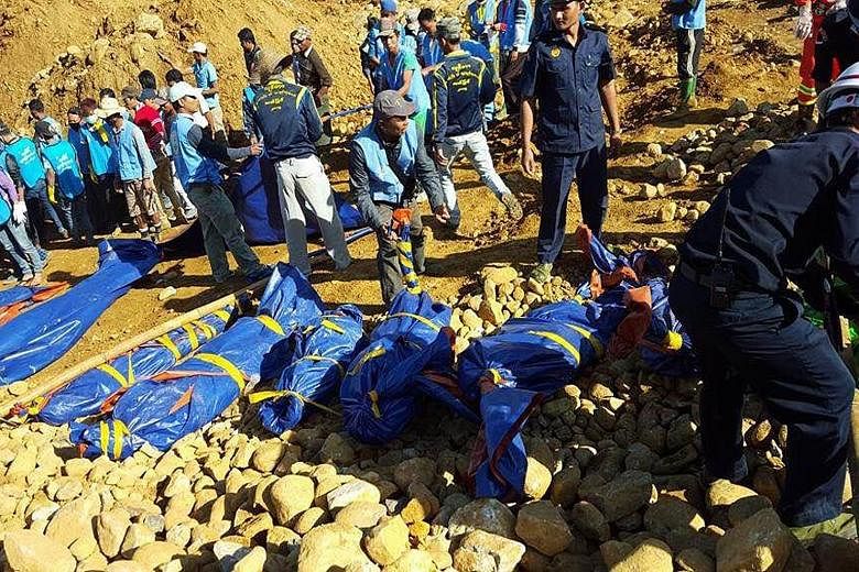 Rescue workers collecting bodies of people killed in the landslide on Saturday in the jade-mining area of Hpakant, in Myanmar's Kachin state. Hpakant produces some of the world's highest-quality jade but its mines and dump sites for debris are rife w