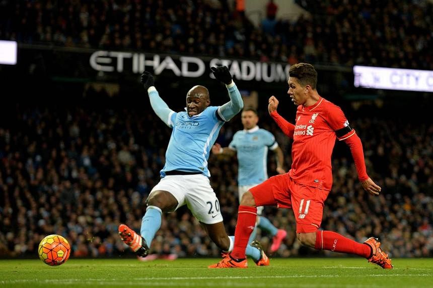 Liverpool’s Roberto Firmino scoring to make it 3-0 in the 33rd minute against Manchester City.