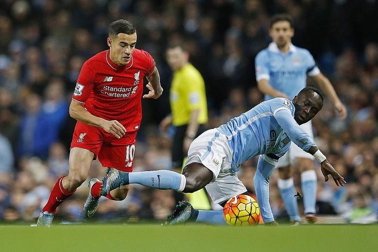 Manchester City's Bacary Sagna (front) slips as Philippe Coutinho of Liverpool is poised to pounce during their Premier League match on Saturday. Following the 4-1 thrashing at the hands of the Reds, Sagna said he was wrong in assuming he was ready t