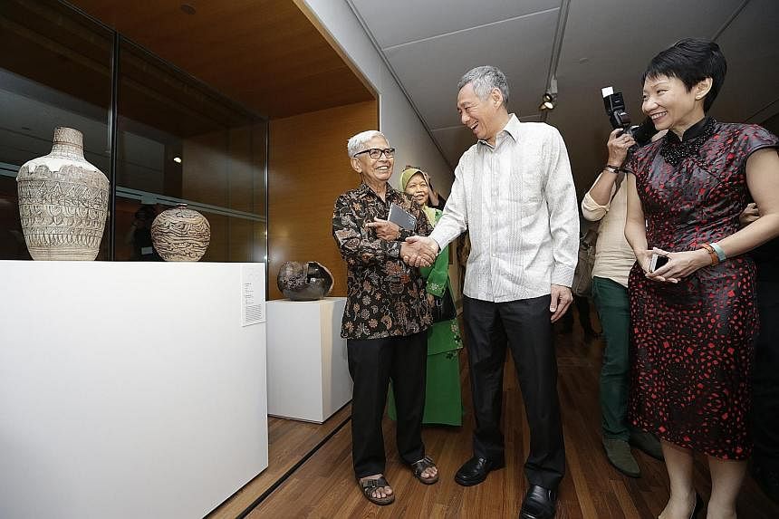 (From left) Potter Iskandar Jalil with PM Lee Hsien Loong and Minister for Culture, Community and Youth Grace Fu at the National Gallery, which will have what is said to be the world's largest collection of South-east Asian art. Guests at the Singtel