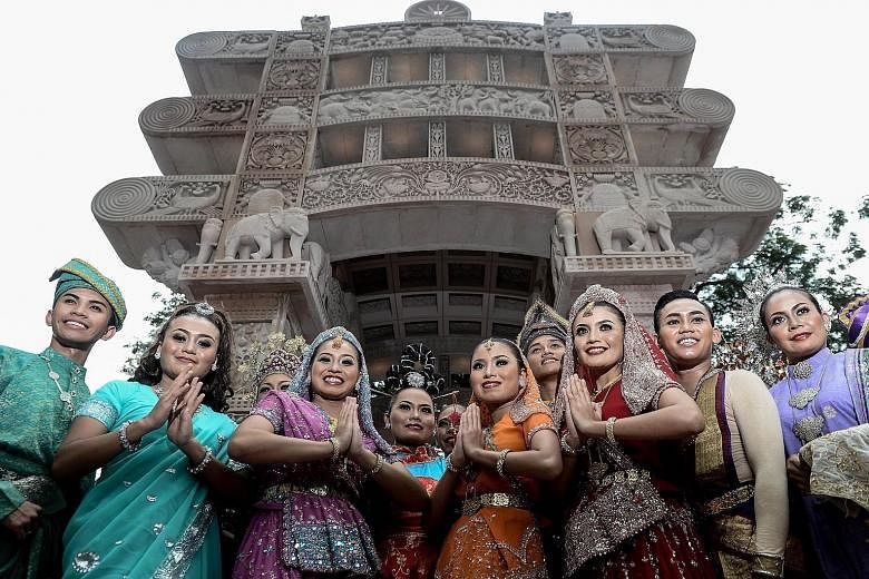 Models dressed in traditional attire in front of the Torana Gate in Kuala Lumpur's Brickfields district, during its inauguration by Malaysian Prime Minister Najib Razak and visiting Indian Prime Minister Narendra Modi yesterday. The gate, installed o