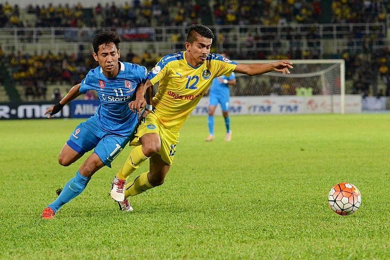 Azammuddin Akil (right) thwarting LionsXII's Nazrul Nazari in a chase for the ball. The hungrier and faster Pahang players were a real handful for the Singapore team, who need to improve tremendously on Saturday.