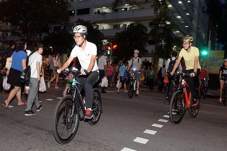 Focus group participants on bicycles in a role-playing exercise in Yishun Ring Road yesterday. Participants used bicycles or other personal mobility devices and also rode on crowded footpaths.