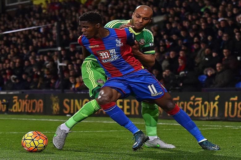 Sunderland defender Younes Kaboul (in green) trying to dispossess Crystal Palace striker Wilfried Zaha. Despite winning 1-0, the Black Cats remain in the relegation zone.