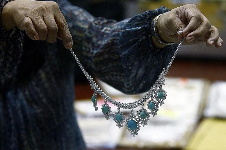 A necklace seized three decades ago from Imelda Marcos, former first lady of the Philippines, being displayed during an appraisal at the Central Bank of the Philippines in Manila yesterday. In a statement, the Presidential Commission on Good Governme