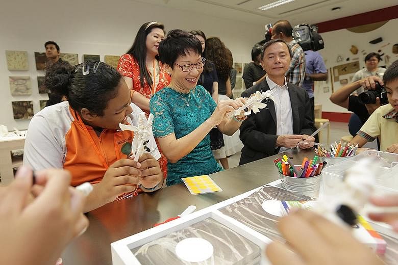 Minister for Culture, Community and Youth Grace Fu (above) interacting with visitors at the National Gallery Singapore's Keppel Centre For Art Education yesterday. With her was museum chairman Hsieh Fu Hua. Many visitors (below) were in high spirits 
