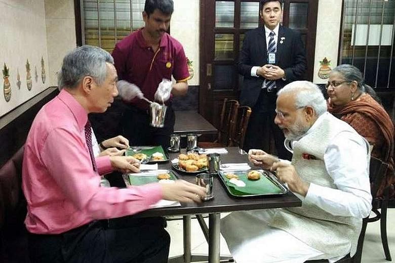 PM Lee and Mrs Lee (hidden) having a meal with Mr Modi at Indian vegetarian restaurant Komala Vilas on Monday night.