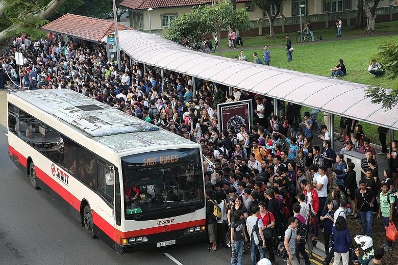 Commuters queuing at a bus stop opposite Bishan MRT Station for free shuttle buses. Train services between the Yishun and Bishan stations in both directions were disrupted for nearly two hours from 5.45am yesterday, affecting more than 70,000 commute