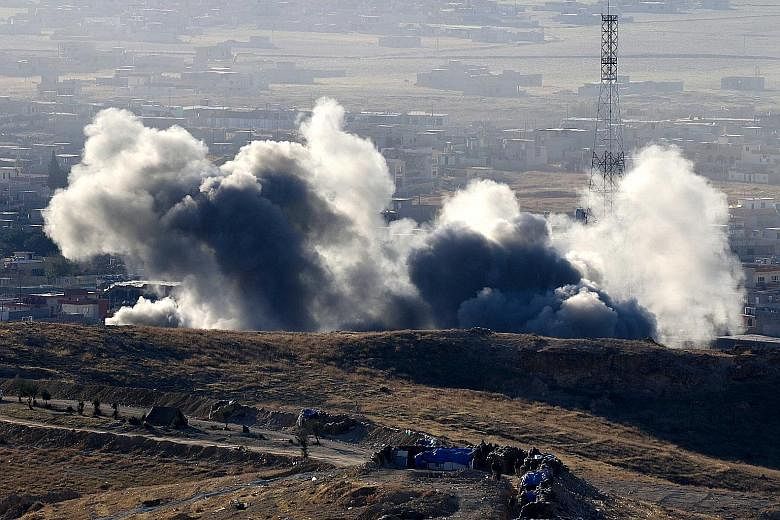 Smoke rising from the northern Iraqi town of Sinjar during an operation earlier this month by Iraqi Kurdish forces, backed by US-led strikes, to retake the town from ISIS and cut a key supply line to Syria.