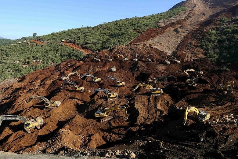 Excavators at the Hpakant jade mine in Kachin state, Myanmar, on Tuesday, during a search for bodies buried after a landslide. Rescue workers have recovered 113 bodies but some 100 people remain missing.