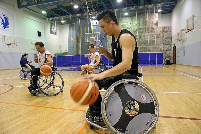 One of the players straps his legs tightly to the wheelchair as sudden upper body movements may cause a player to fall out of his wheelchairs.