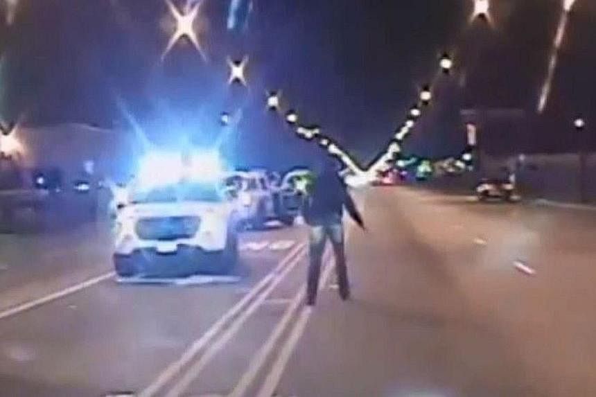 Video footage released by Chicago police shows (from left) teenager Laquan McDonald walking past police cars carrying a knife, then looking at the police before being shot, and on the ground after the shooting. Protesters took to the streets of downt