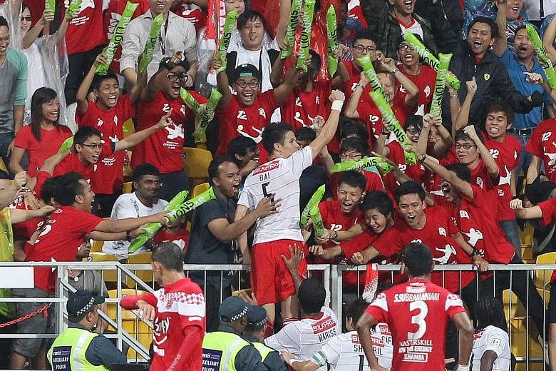 FIRST GOAL: The LionsXII's Baihakki Khaizan celebrating with delighted fans, after opening accounts during the team's 1-2 loss in their first MSL match against Kelantan on Jan 10, 2012 at the Jalan Besar Stadium.