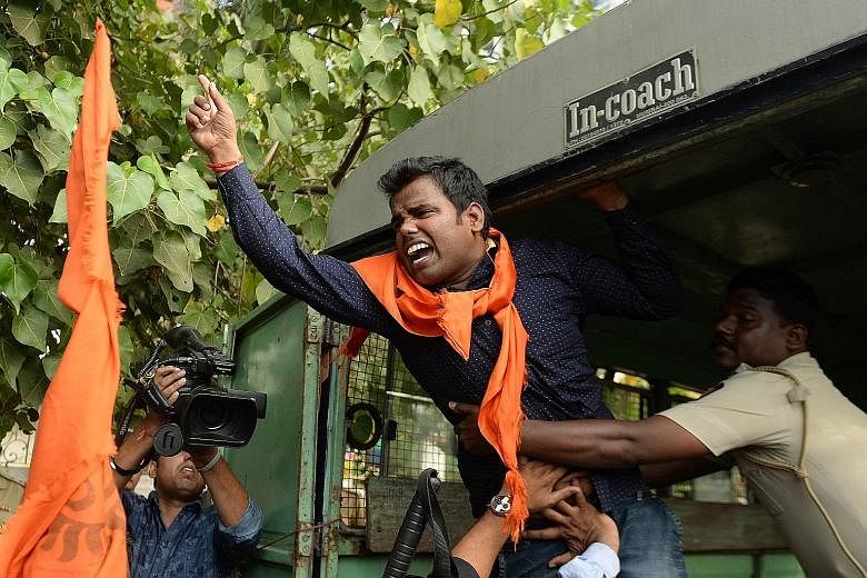 An Indian activist shouts slogans as he is detained by police outside the home of Bollywood actor Aamir Khan in Mumbai on Tuesday. Khan had complained of rising intolerance in his homeland. Bollywood actor Aamir Khan, who is Muslim, and his Hindu wif