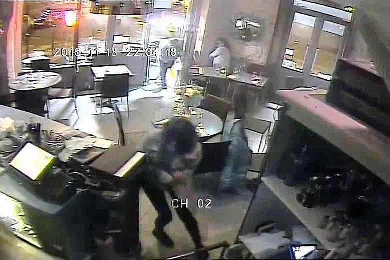 An image from the video released by the Daily Mail that shows people fleeing as bullets fly. The paper is alleged to have paid €50,000 for the footage, captured by CCTV cameras at Paris' Casa Nostra pizzeria.