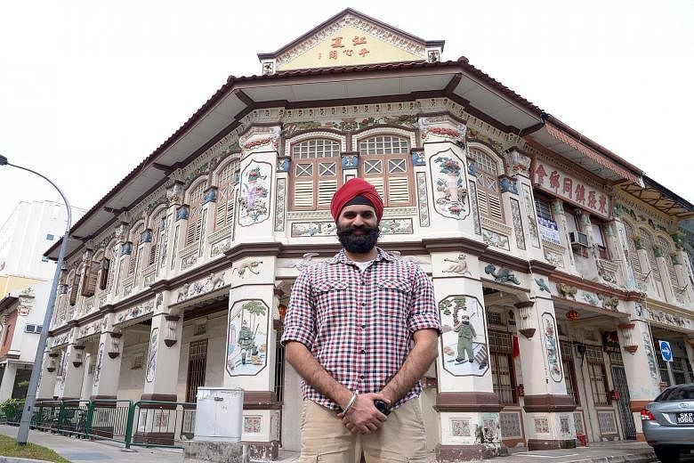 Mr Ishvinder Singh, a co-developer of the Sikh Heritage Trail app, at a traditional shophouse in Lorong Bachok in Geylang, which has carvings of Sikh guards, designed to "watch over" the building.