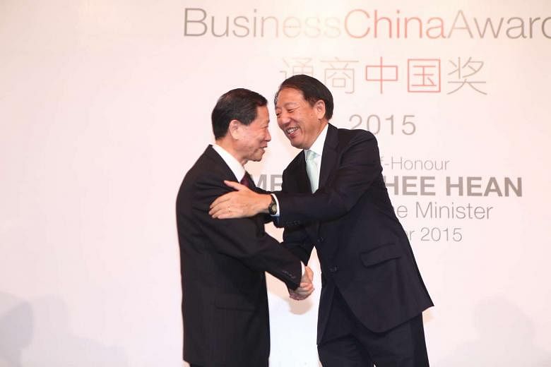 Singapore Deputy Prime Minister Teo Chee Hean (right) congratulates Mr Li Rongrong, 71, the founding chairman of China's State-Owned Assets Supervision and Administration of the State Council, for winning the Business China Award. Mr Li was honoured for b