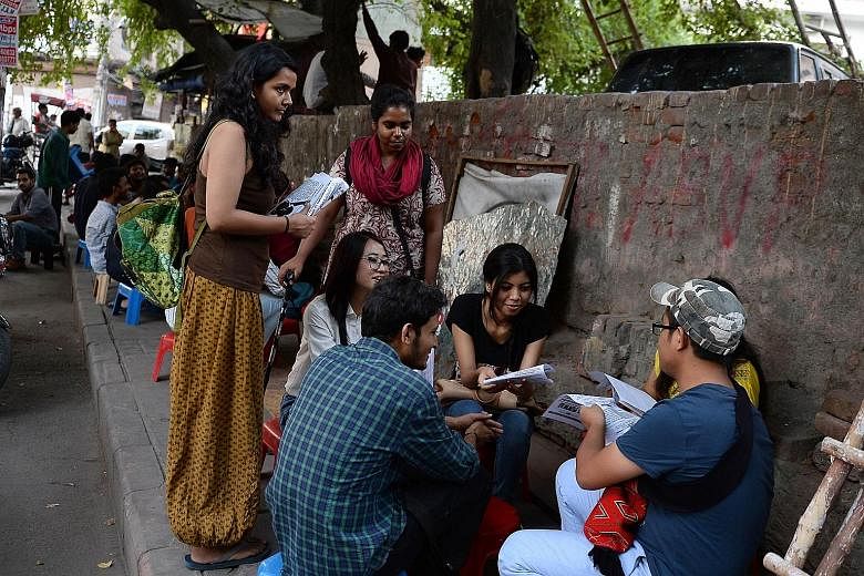 Indian student activists distributing leaflets outside Delhi University's North Campus in New Delhi. Through the Pinjra Tod (Break the Cage) campaign, launched in August, female students want more control over their lives in hostels and to have the s