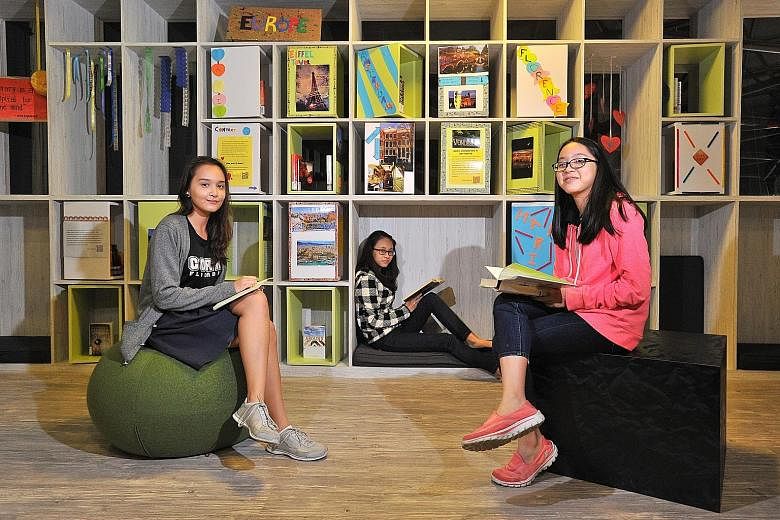 (From left) Coral Secondary student Eliisa Abdullah, 15; Springfield Secondary student Mo Mo Banyar, 13; and CHIJ St Nicholas Girls' Secondary student Natalie Goh Hui Shi, 14, at the new Teens' Mezzanine at Pasir Ris Public Library. The new mezzanine