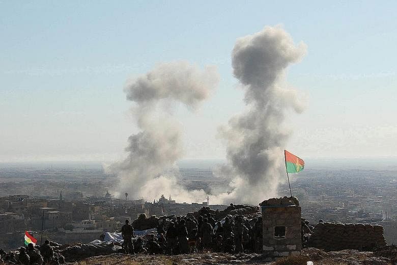 Smoke rising from the site of US-led air strikes against ISIS militants in the town of Sinjar, Iraq, on Nov 13. However, in general, analysts say the fight against the terrorist group has made very slow progress.