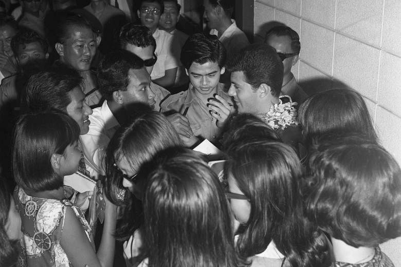 Avid fans swarming around teen idol Frankie Avalon on his arrival here to promote a new film.