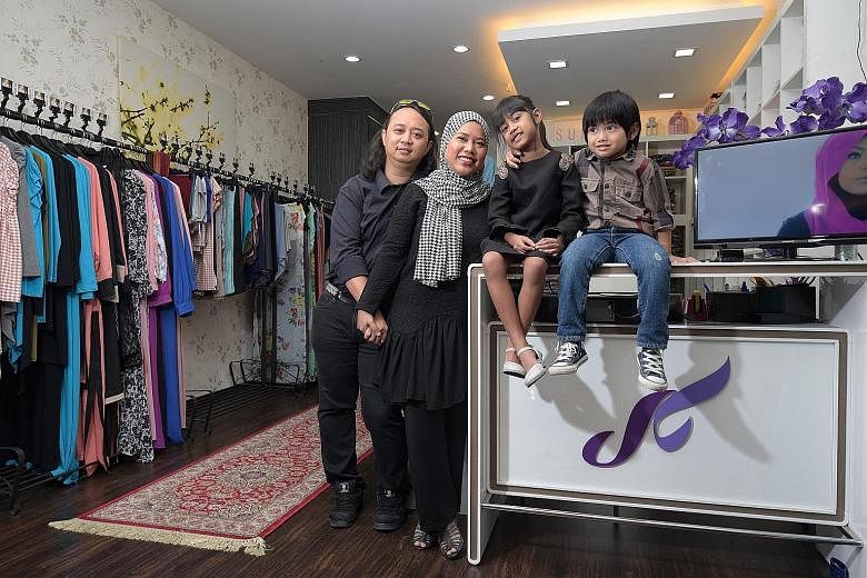 Ms Azrina Tahar with husband Jasman Johari, daughter Sufia Jaide and son Wildan at her shop in Tanjong Katong Complex. Her ambition is to turn Sufyaa into a one-stop fashion house, with services ranging from manufacturing to photography to even consu
