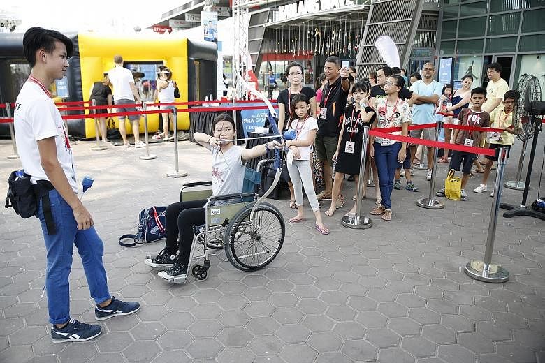 A visitor at the Asean Para Games Carnival trying out wheelchair archery.The carnival is open until Dec 9, from 10am to 9pm, and 8am to 9pm on Dec 5.