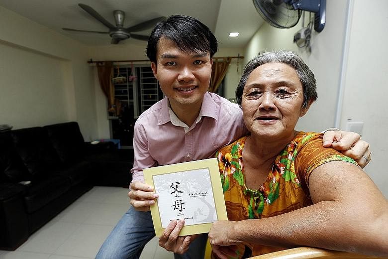 Mr Tan Chin Hock and his mother, Madam Foo Lian, holding the book Father, Mother that Mr Tan authored.
