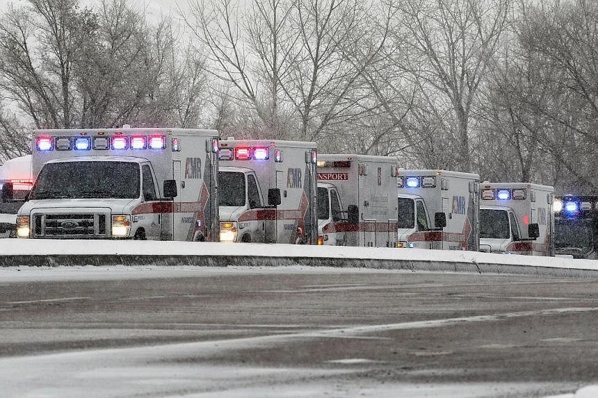 The suspect has been identified by police as Robert Lewis Dear (above). Ambulances at the scene of the shooting (left).