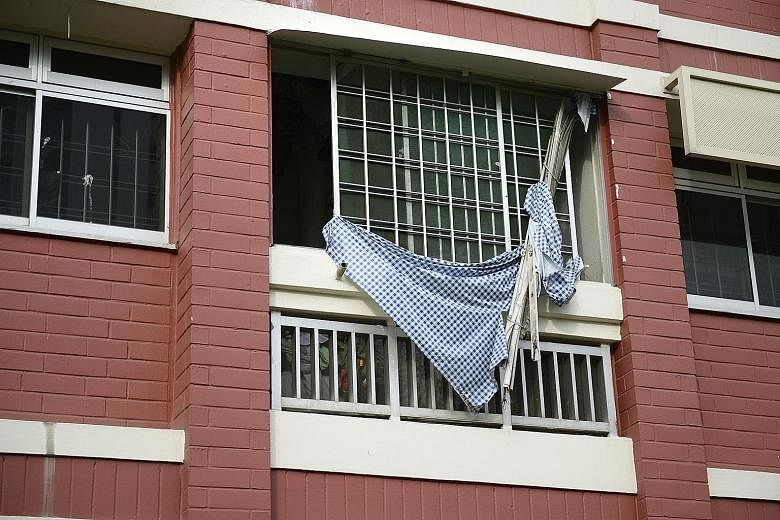 Mr Liew Chien Siong's flat, which once had a window blind dangling outside, forcing the town council to cordon off an area below the unit for safety reasons.