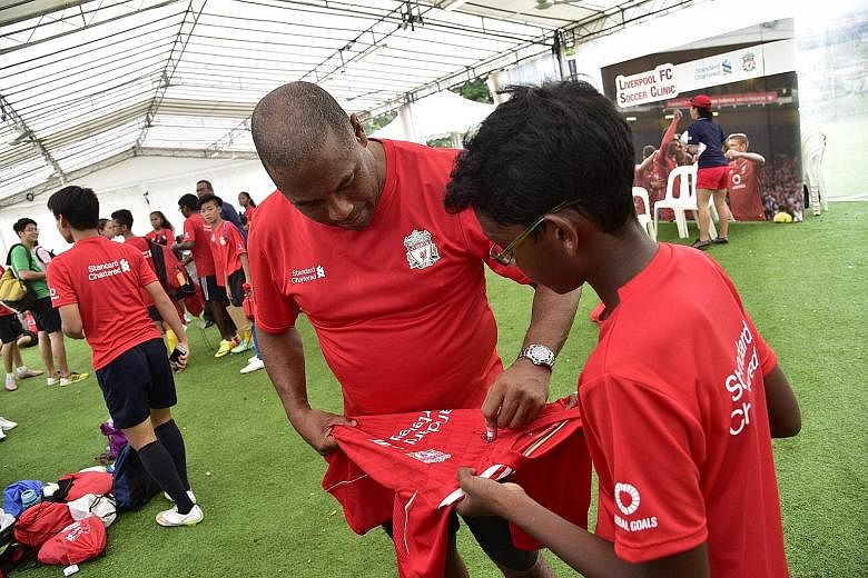 Former Liverpool star John Barnes signing an autograph. He is in town to help conduct a football clinic for youngsters.