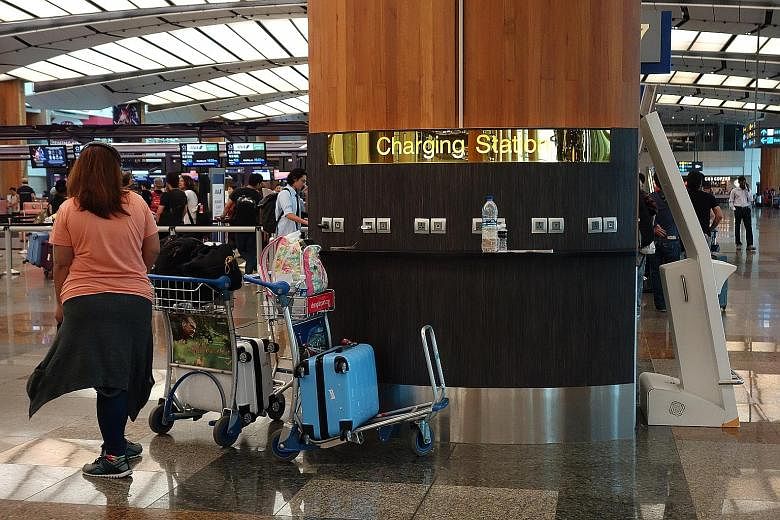 A cellphone charging station at Changi Airport Terminal 2 departure hall. The airport has installed 880 mobile phone charging stations, 23 hot water dispensers and water coolers in its gate hold rooms at the request of travellers.