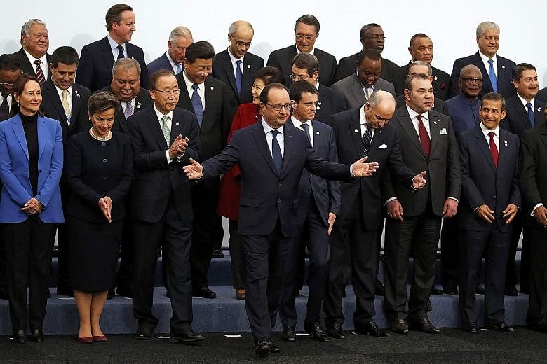 French President Francois Hollande (centre) gathering with world leaders for a group photo on the opening day of the United Nations Climate Change Conference 2015 at Le Bourget, near Paris, yesterday. As host, Mr Hollande told the world leaders that 