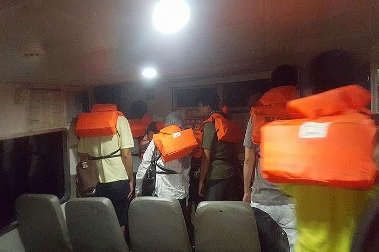 The passengers put on life vests and got off the ferry and onto life rafts after it was hit by a floating object.