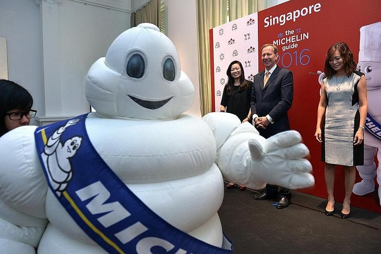 Announcing the launch of Michelin Guide's bilingual Singapore edition next year are (from left) Ms Melissa Ow, deputy chief executive of the Singapore Tourism Board; Mr Michael Ellis of Michelin Guides International; and Ms Michelle Ling, director of