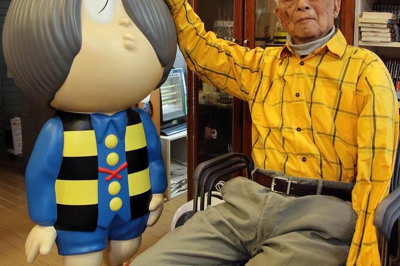 The late Japanese comic artist Shigeru Mizuki sitting next to his famous character "Kitaro" in his studio in Tokyo earlier this year.