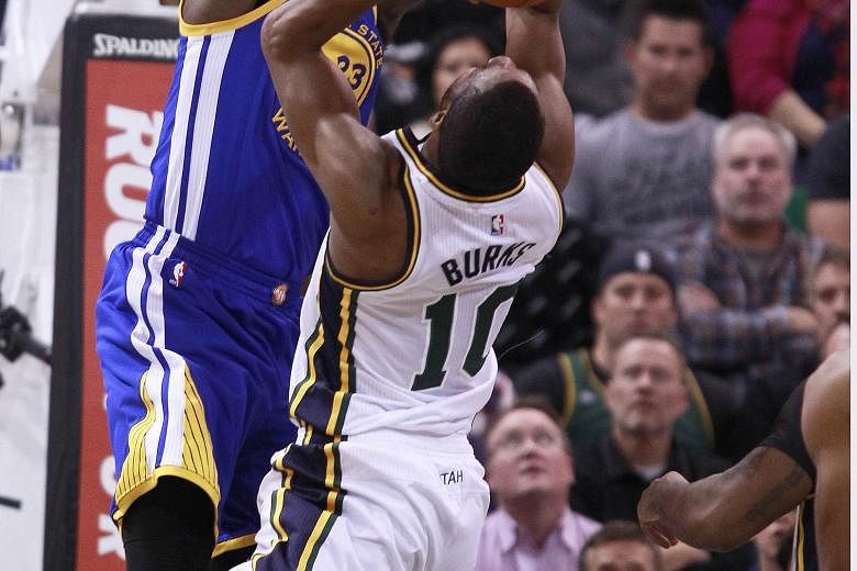 With every NBA team hoping to end the Golden State Warriors' winning streak, forward Draymond Green (left) makes sure he brings his 'A' game to stop the threat from Utah Jazz guard Alec Burks.