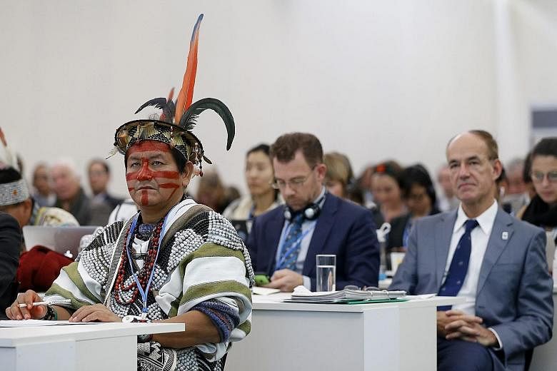 A Peruvian visitor attending a press conference on deforestation at the COP21 World Climate Change Conference 2015 in Le Bourget, north of Paris, France, on Tuesday. The 21st Conference of the Parties (COP21) started on Monday and ends on Dec 11. It 