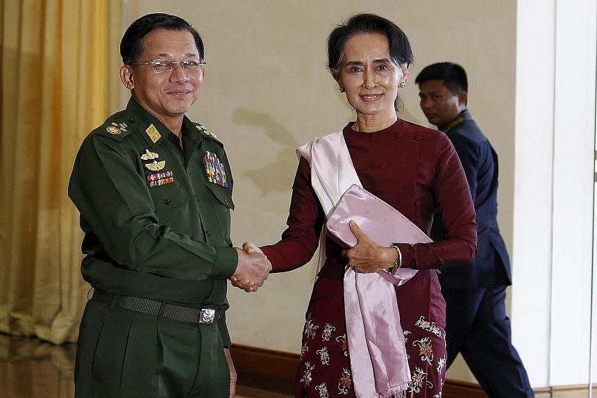 Above, left: Ms Suu Kyi and Mr Thein Sein during a meeting at his Naypyitaw office yesterday, where he congratulated her on NLD's victory. The opposition leader also met army chief Min Aung Hlaing and they agreed "to cooperate on stability and peace,