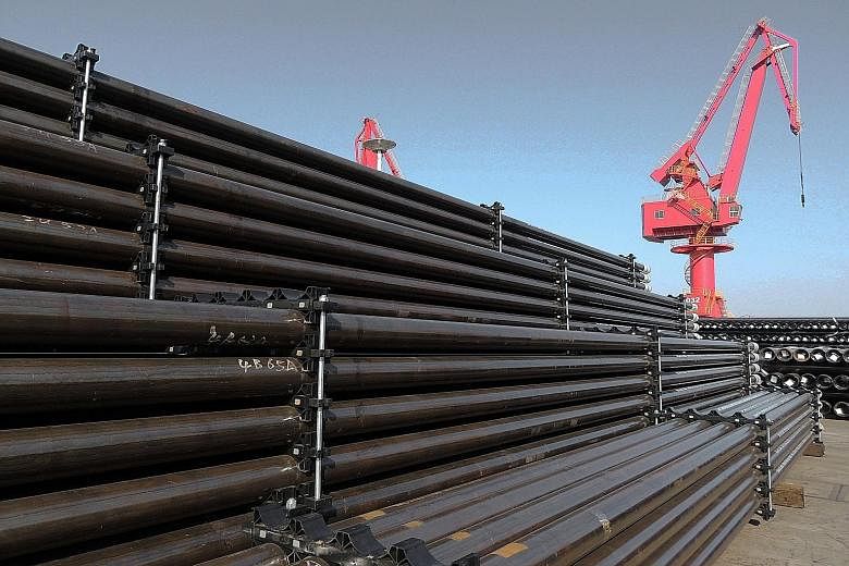 Steel pipes at a port in Jiangsu, China. Tepid growth in Singapore is due to headwinds in China, whose growth will slow down towards the 6.2 per cent to 6.5 per cent range, says UBS' Tan Min Lan.