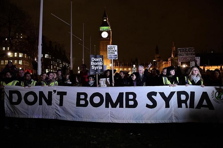 Protesters against British military action in Syria gathered outside the Houses of Parliament in London on Tuesday.