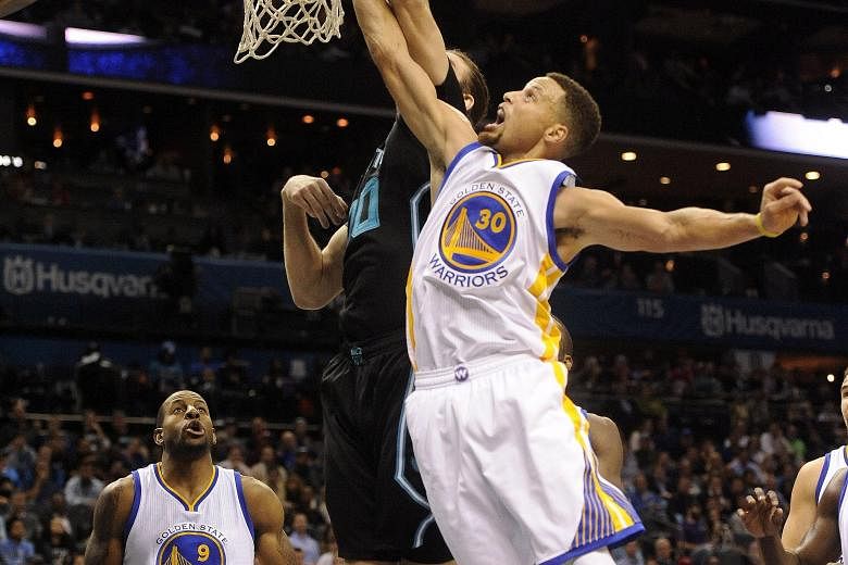 Stephen Curry (right) fighting for a rebound against Charlotte Hornets. He finished as Golden State Warriors' top scorer for the fifth straight game in the 116-99 win.